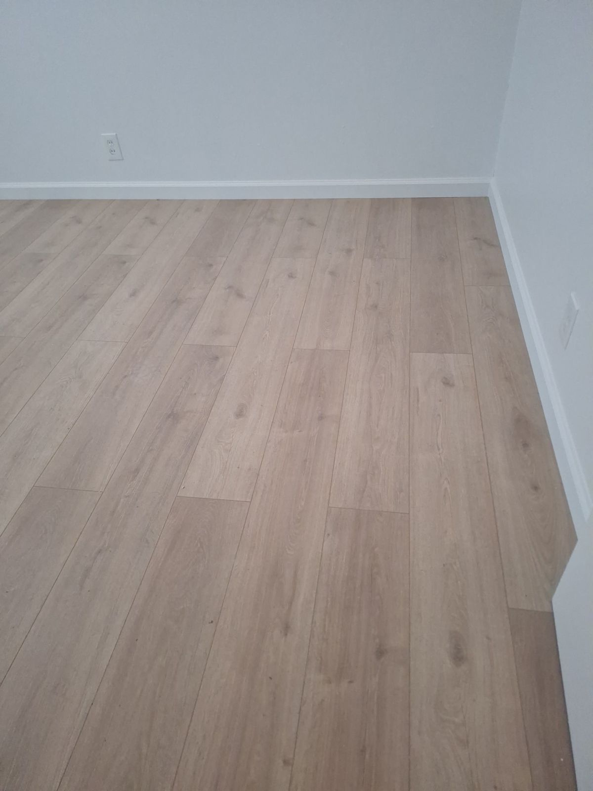 Wood-look plank flooring with new baseboards
